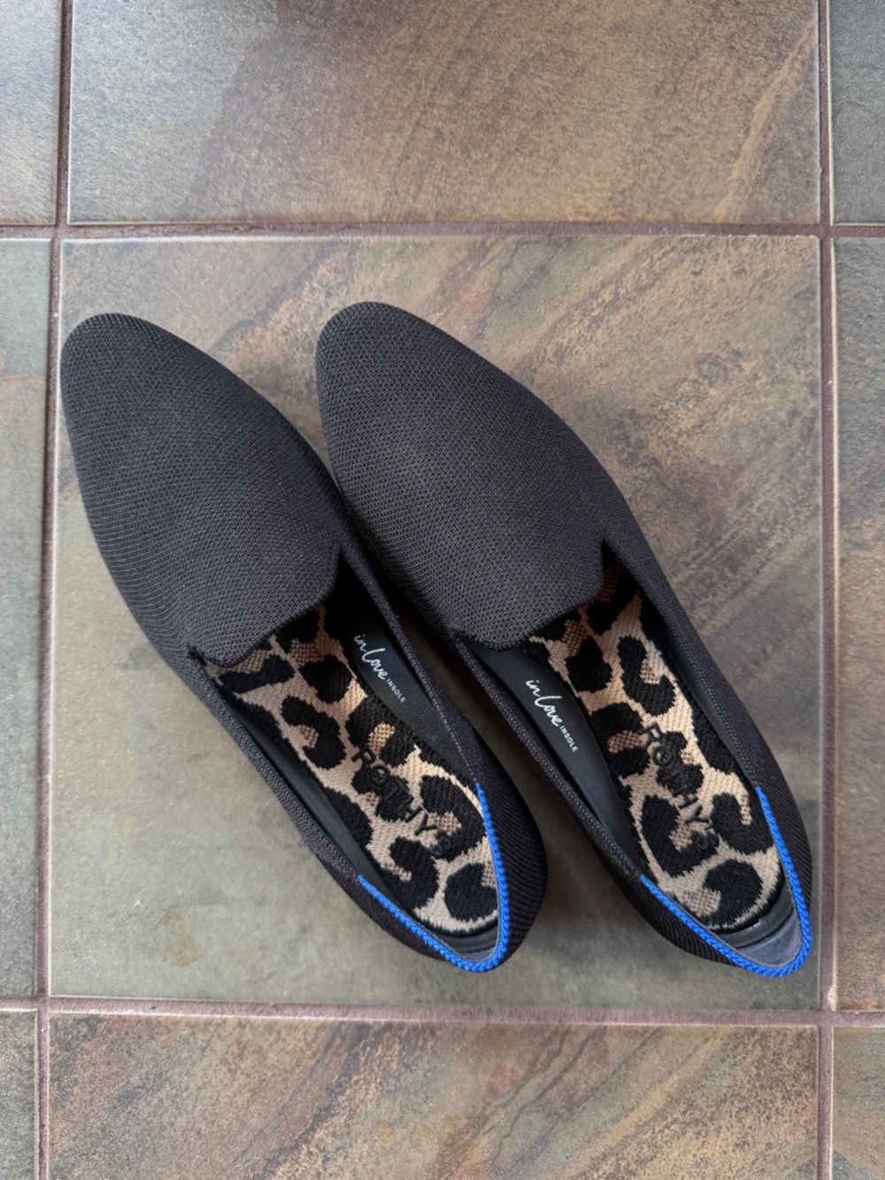 Rothy’s Black Slip-On Flats with Leopard Insole and Blue Trim. Machine washable